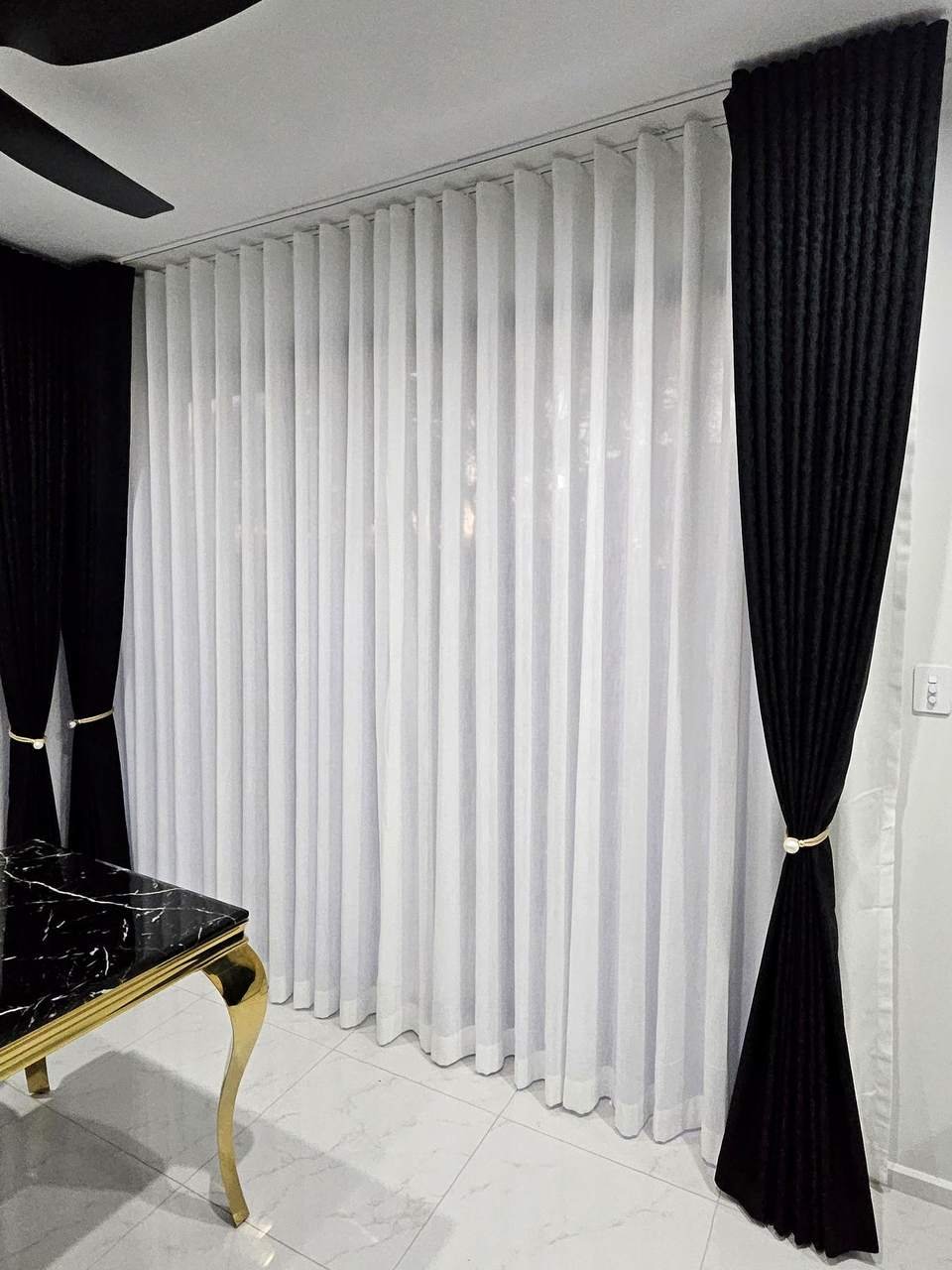 Black blockout curtains and white sheers on a double track