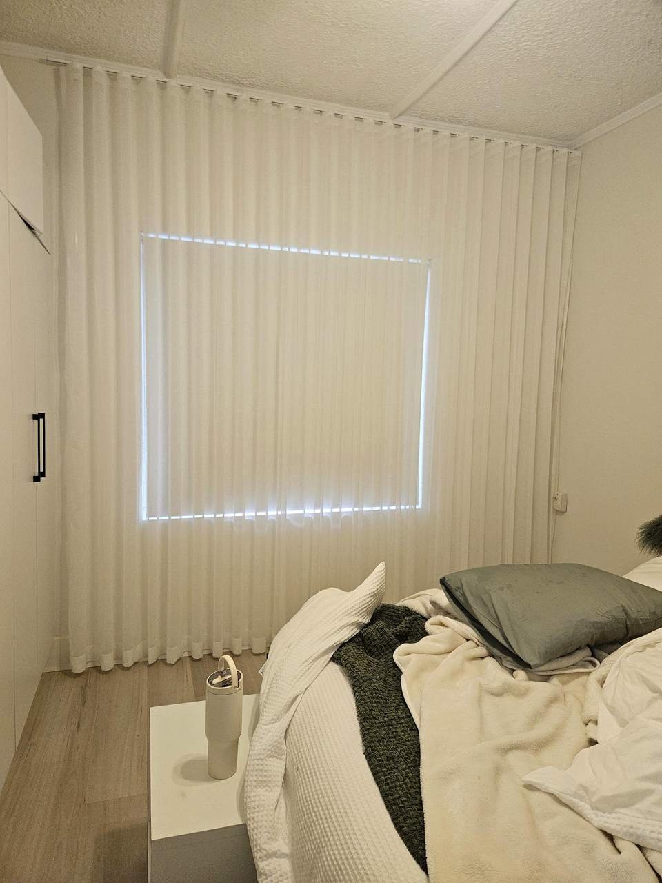 White blockout curtains darkening a bedroom