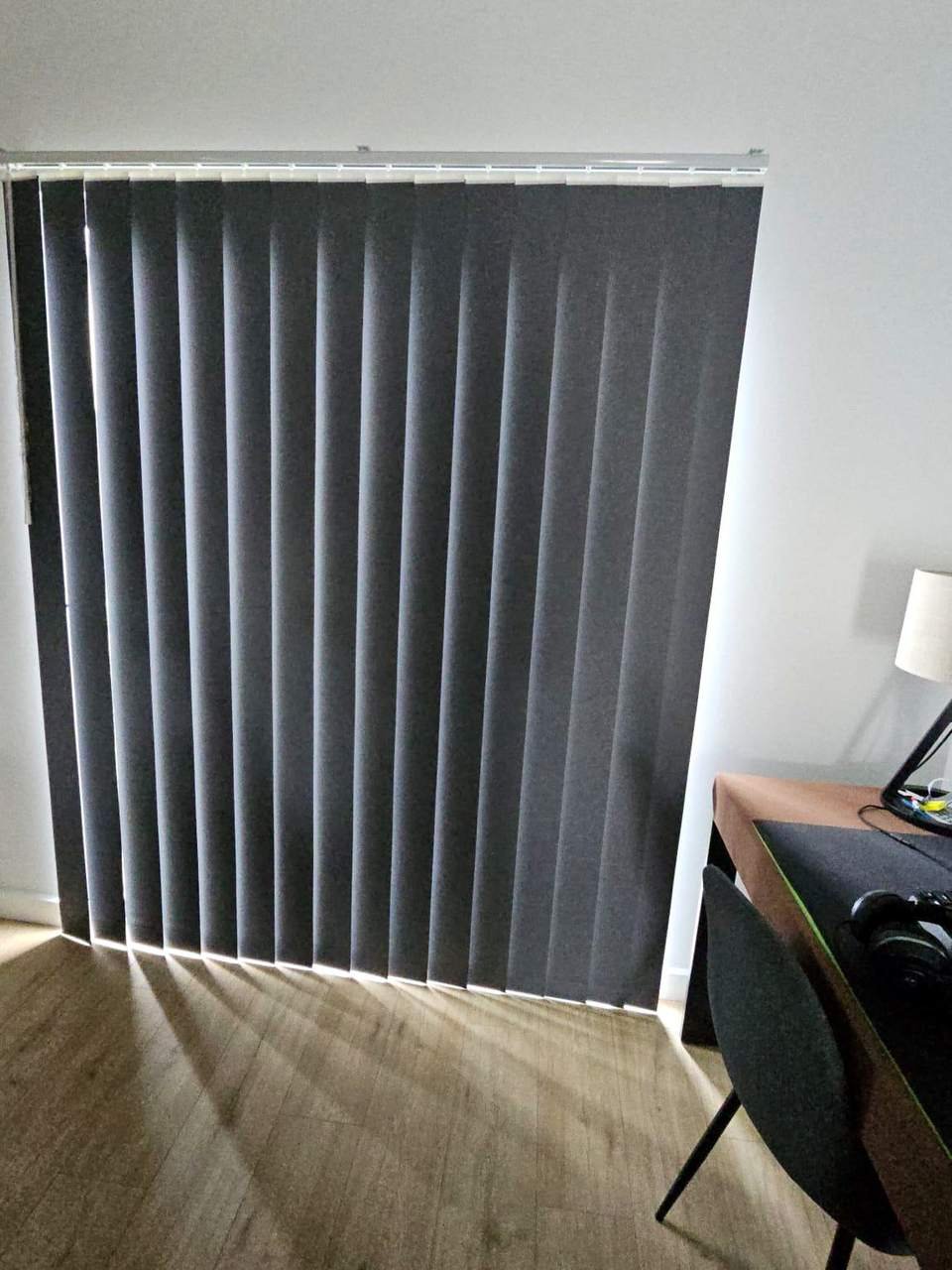 Charcoal blockout vertical blinds on a sliding door