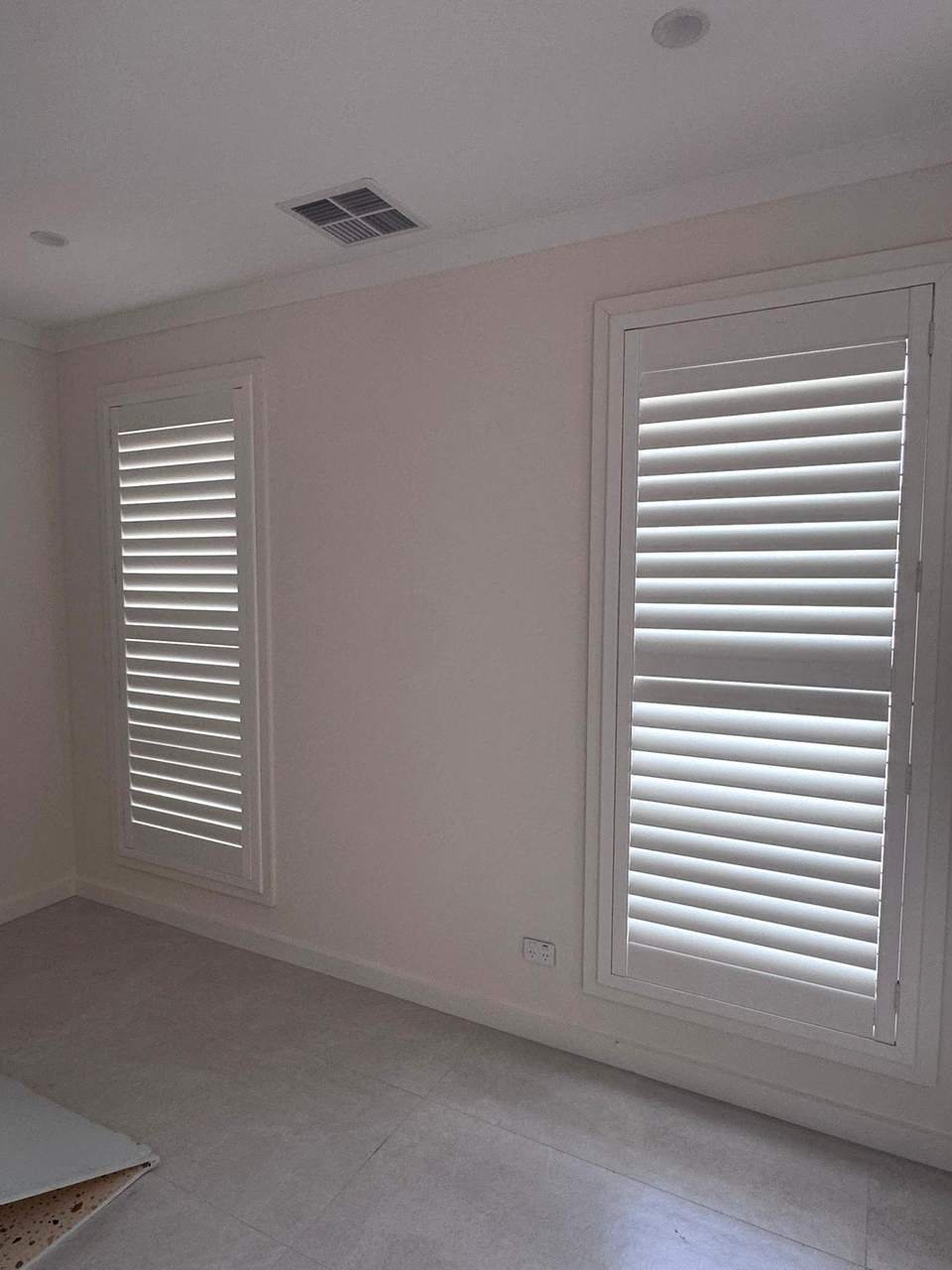 White plantation shutters on two bedroom windows