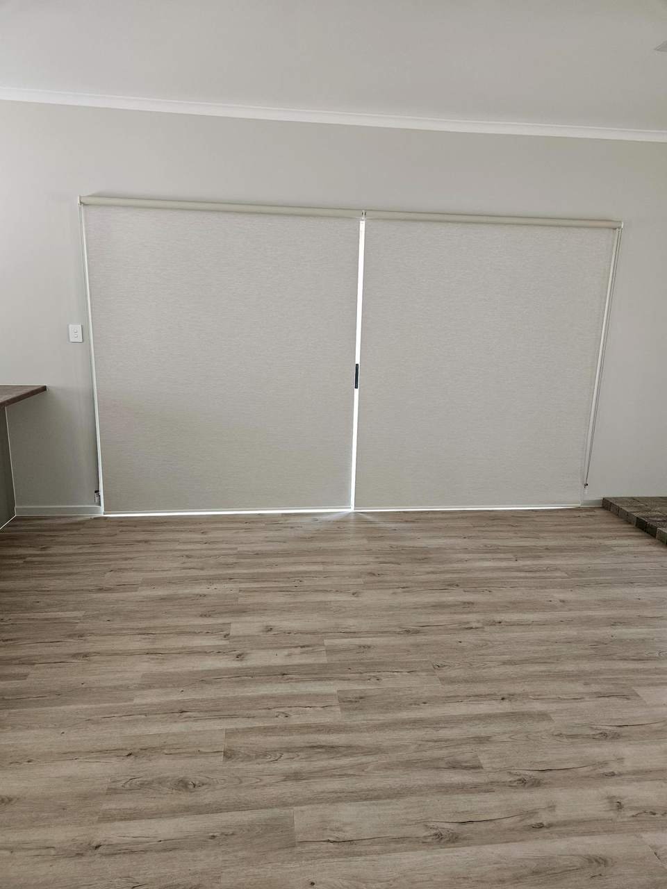 Roller blinds lowered over a sliding door