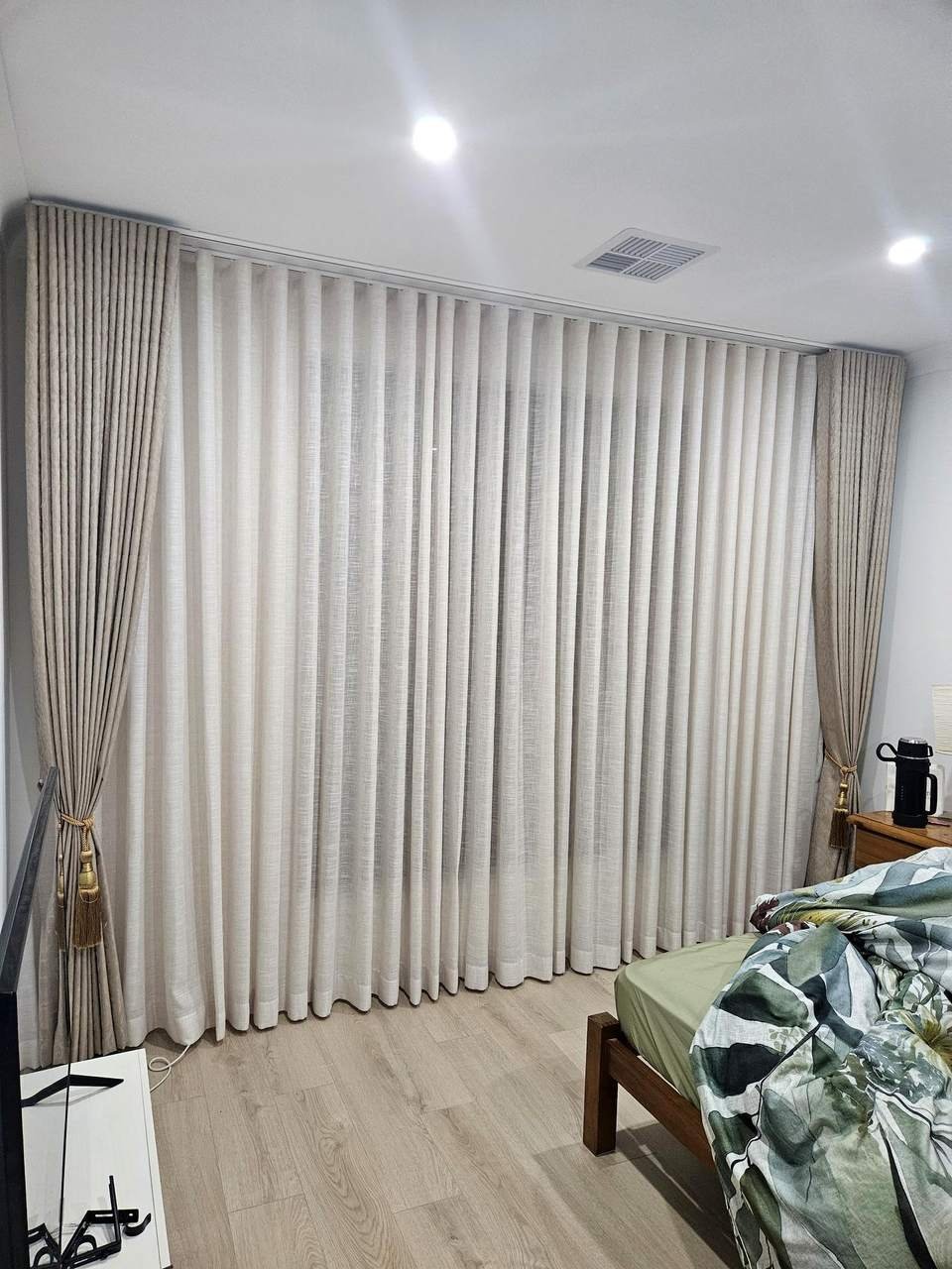 Sheer curtains layered with linen curtains and tiebacks